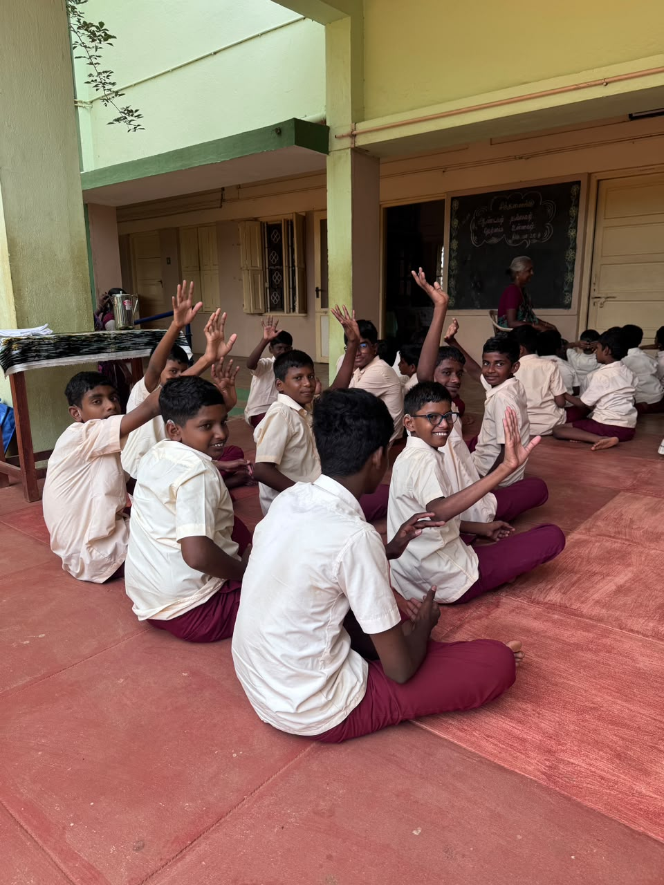Students joyfully raising hands at Dolours High School for the Hearing Impaired